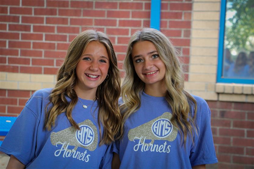 Two students smile